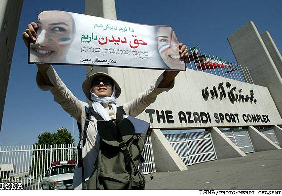 A woman protests outside The Azadi Stadium in Tehran, Iran